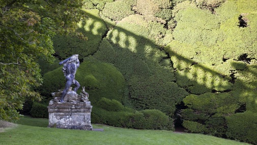 The lead statue of Hercules made by Andries Carpentiere in the workshop of John van Nost, in the garden in July at Powis Castle, Powys, Wales.